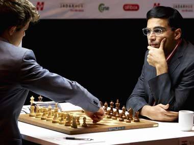 Magnus Calsen makes a move while Viswanathan Anand watches. AFP