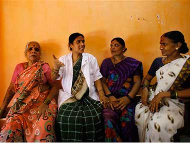 A local health worker, (second from left) speaks about cervical cancer to a group of women from a slum in Mumbai. AP