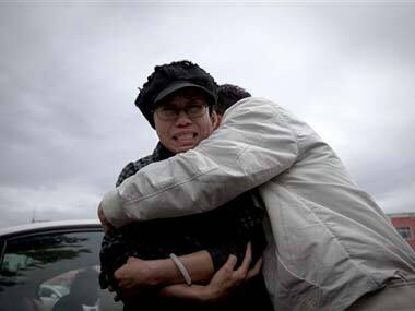A relative comforts Liu Xia, left, wife of imprisoned Nobel Peace Prize winner Liu Xiaobo, while she cries outside Huairou Detention Center where her brother Liu Hui has been jailed in Huairou district: AP