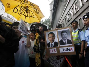 File photo of supporters of Edward Snowden holding a picture of U.S. President Barack Obama and Chinese President Xi Jinping during a demonstration outside the Consulate General of the United States in Hong Kong. AP