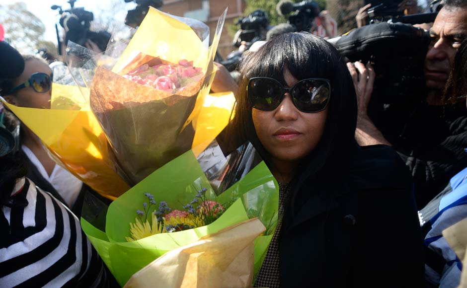 A group of unidentified relatives carry bunches of flowers that were left by wellwishers back into the Mediclinic Heart Hospital where former South African President Nelson Mandela is being treated in Pretoria: Reuters A group of unidentified relatives carry bunches of flowers that were left by wellwishers back into the Mediclinic Heart Hospital where former South African President Nelson Mandela is being treated in Pretoria: Reuters