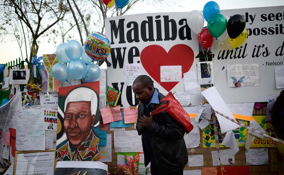 A man prays as he pays his respects outside the Medi-Clinic Heart Hospital, where ailing former South African President Nelson Mandela is being treated, in Pretoria: Reuters A man prays as he pays his respects outside the Medi-Clinic Heart Hospital, where ailing former South African President Nelson Mandela is being treated, in Pretoria: Reuters