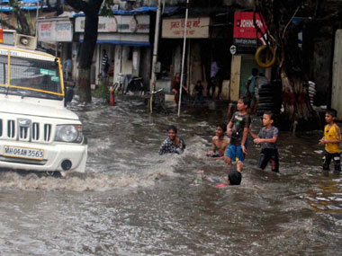 Torrential rains lash Mumbai, local trains delayed Torrential rains lash Mumbai, local trains delayed