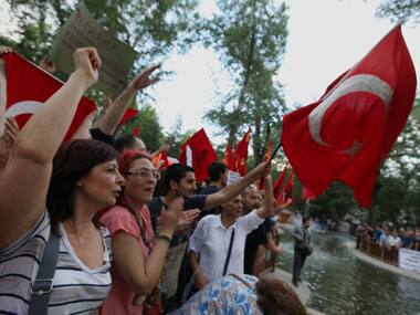 Thousands of people gather in support of demonstrators staging a sit-in to prevent the uprooting of trees at an Istanbul park, in Ankara. AP