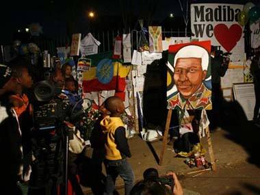 Children and their families stand outside the Mediclinic Heart Hospital where former South African President Nelson Mandela is being treated. AP image