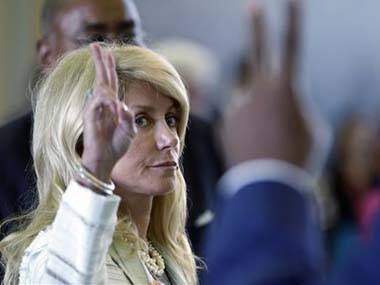 Sen. Wendy Davis, left, votes against the anti-abortion bill. AP image