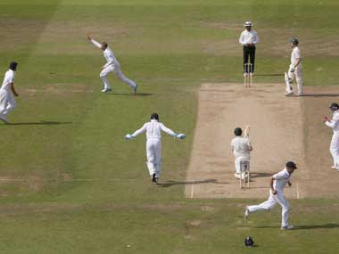 England's Joe Root, upper centre left, celebrates after taking the wicket of Australia's Ed Cowan, lower centre right, caught by Jonathan Trott for 14 on the fourth day of the opening Ashes series cricket match at Trent Bridge cricket ground, Nottingham, England, Saturday. AP