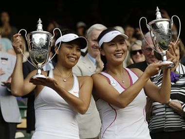 Su-Wei Hsieh of Taiwan, left, and Shuai Peng of China pose with their trophies after winning against Ashleigh Barty of Australia and Casey Dellacqua of Australia. AP