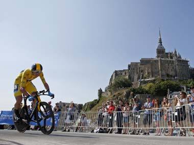 Team Sky rider yellow jersey holder Christopher Froome of Britain cycles past the Mont Saint-Michel during the 32 km individual time trial eleventh stage of the centenary Tour de France. Reuters