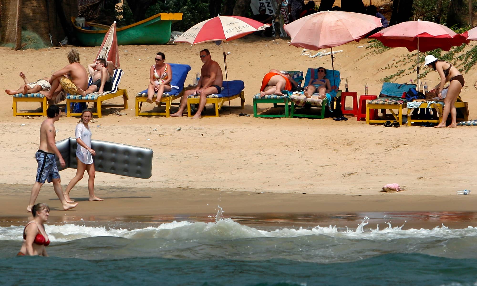 Tourists relax at the Anjuna beach in Goa. Reuters