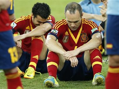 Spain's Andres Iniesta, center, and Pedro Rodriguez, left, sit dejected on the pitch after losing the Confederations Cup final. AP