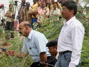 File photo shows suspended police officers Tarun Barot (holding revolver) and G.L Singhal (R) during a reconstruction of Ishrat Jehan encounter by CBI. PTI
