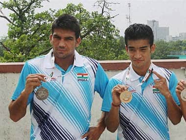 Mandeep Jangra (left), and Shiva Thapa with show off their medals from the Asian Boxing Championships. PTI