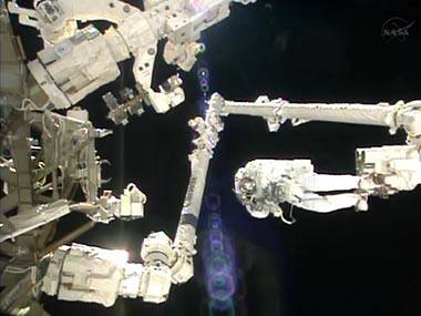In this image made from video provided by NASA, Italian astronaut Luca Parmitano stands on the end of a robotic arm during a spacewalk outside the International Space Station. AP 