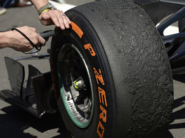 The tyres on Mercedes Formula One driver Rosberg of Germany's car are checked by an official after the British Grand Prix. Reuters