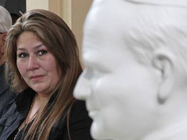 Costa Rica's Floribeth Mora looks at a bust of Pope John Paul II while giving her account of a miracle attributed to John Paul, during a press conference. AP