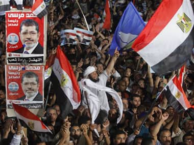 Supporters of Mohammed Morsi wave national flags during a rally in Cairo. AP image