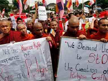 Buddhist monks hold placards during a protest rally against the Time Magazine's article. AP