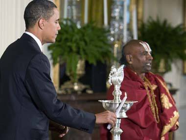 US President Barack Obama lights a lamp on the occasion of Diwali at the White House. Agencies