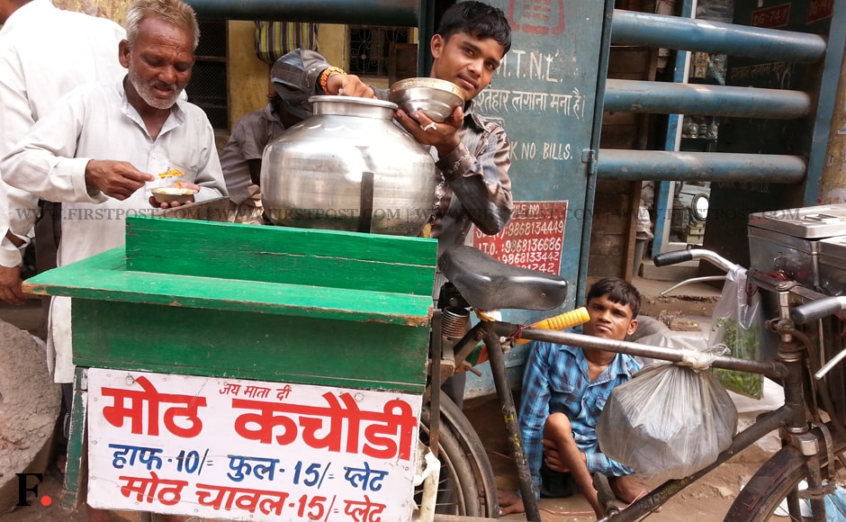 Eighteen year old Vikas Kumar from Faizapur in UP, has been selling 'moth' dal and kachori in Chawdi Bazaar, on his cycle since the past five months. He sells half plate of 'moth' dal and kachori for Rs. 10 and a full plate for Rs. 15. Arlene Chang/Firstpost. Eighteen year old Vikas Kumar from Faizapur in UP, has been selling 'moth' dal and kachori in Chawdi Bazaar, on his cycle since the past five months. He sells half plate of 'moth' dal and kachori for Rs. 10 and a full plate for Rs. 15. Arlene Chang/Firstpost.