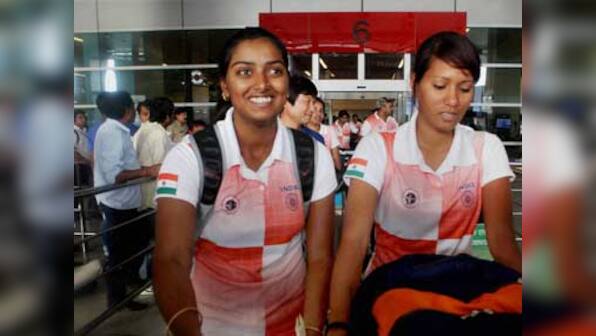 Gold-medal winning archery team come home to drab welcome