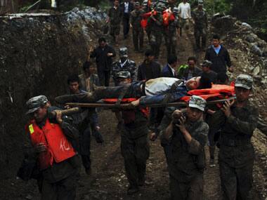 Rescuers evacuate residents from a landslide hit Niangniangba area in Tianshui City in northwest China's Gansu Province. AP