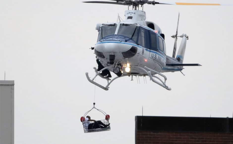 A helicopter pulls what appears to be a shooting victim up as it hovers over a rooftop on the Washington Navy Yard campus in Washington, September 16, 2013. The U.S. Navy said several people were injured and there were possible fatalities in the shooting at the Navy Yard in Washington D.C. on Monday. The Navy did not immediately provide additional details but a Washington police spokesman said earlier that five people had been shot, including a District of Columbia police officer and one other law enforcement officer. REUTERS/Jason Reed 