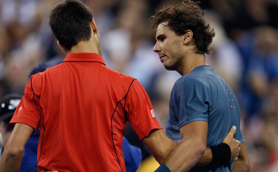 Rafael Nadal of Spain is congratulated by Novak Djokovic of Serbia (L) after his victory in their men's final match at the U.S. Open tennis championships in New York, September 9, 2013. REUTERS