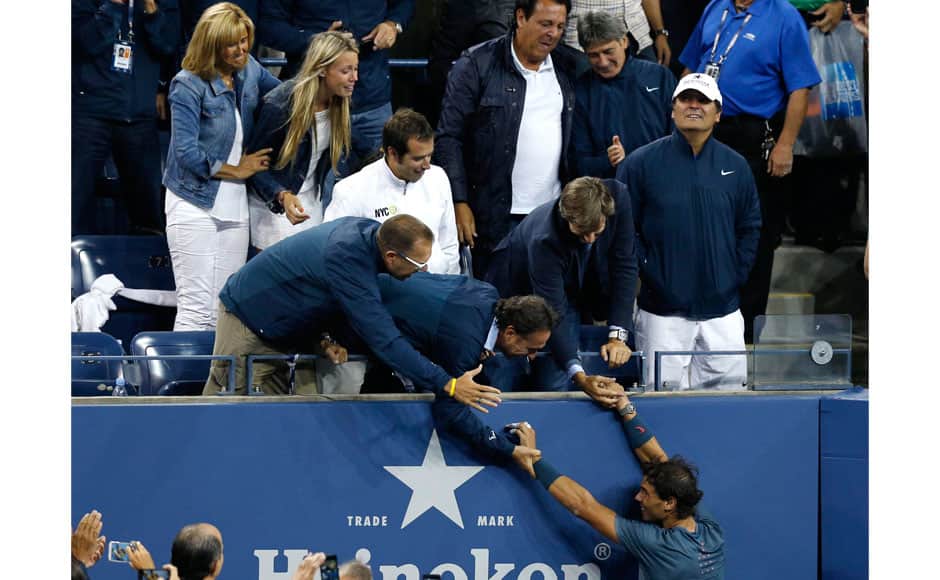 Rafael Nadal of Spain greets friends and family in the stands as he celebrates after defeating Novak Djokovic of Serbia in their men's final match at the U.S. Open tennis championships in New York, September 9, 2013. REUTERS