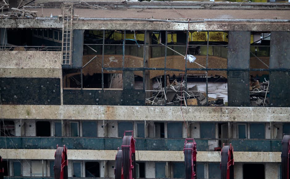 The damaged side of the capsized cruise liner Costa Concordia is seen at the end of the 