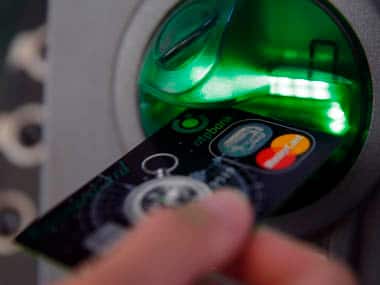 A customer performs a transaction on an ATM at a branch of Hungary's largest lender OTP Bank in central Budapest. Reuters