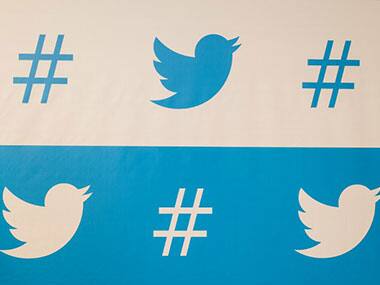 Twitter logo and hashtags are seen in this file photo. AFP 