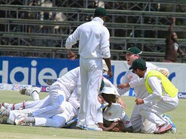 Zimbabwean players celebrate after beating Pakistan by 24 runs on the last day of the last test match of the series at the Harare Sports Club in Harare. AP