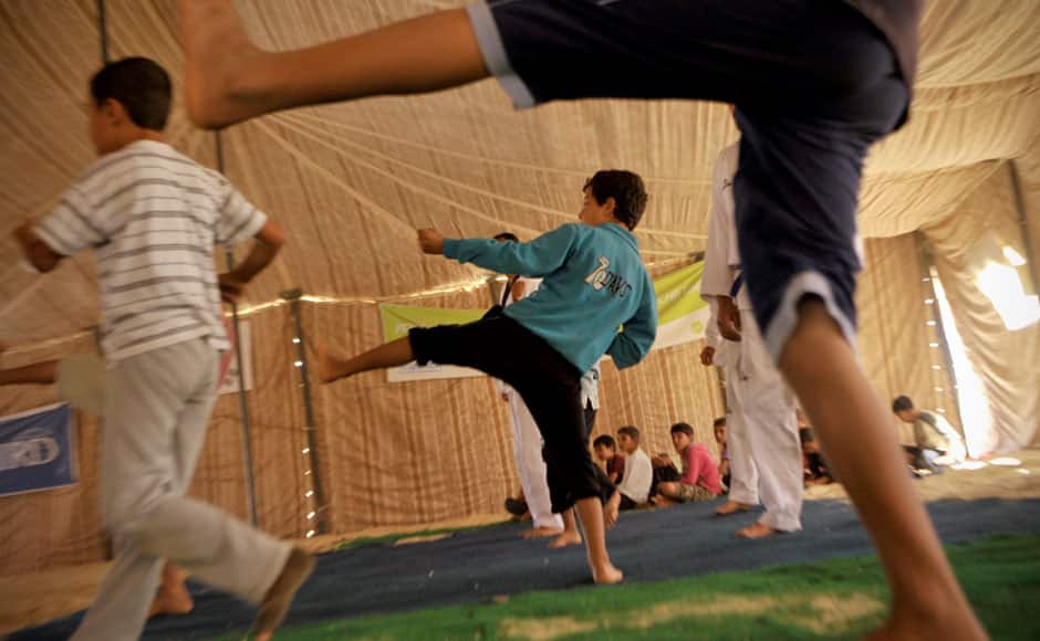 Syrian refugee children participate in Taekwondo training at Zaatari refugee camp, near Mafraq, Jordan. AP Photo/Bela Szandelszky. 