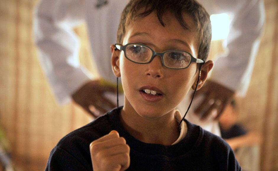 A Syrian refugee boy looks at his Korean Taekwondo instructor at Zaatari refugee camp. AP Photo/Bela Szandelszky