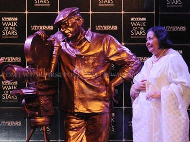 Pamela Chopra standing next to a statue of Yash Chopra. Sachin Gokhale/Firstpost