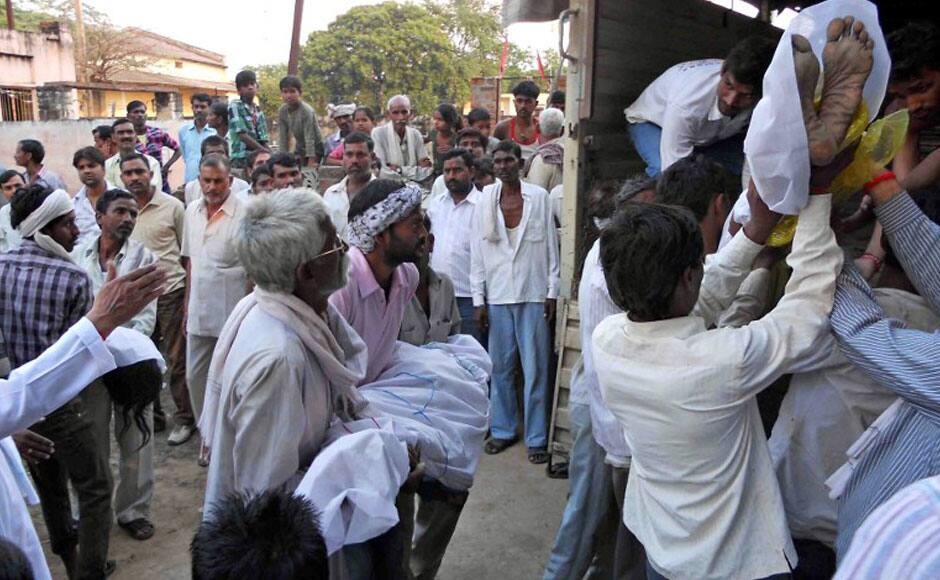 Bodies of Hindu devotees are loaded onto a truck following a stampede outside the Ratangarh Temple in Datia district, India's Madhya Pradesh state, on October 13, 2013. A stampede on a bridge outside a Hindu temple killed at least 60 people in India and dozens more may have died after they leapt into the water below, police said. AFP