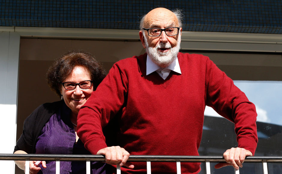 Belgian physicist Francois Englert reacts next to his wife Mira as they appear at the balcony of his house in Brussels after he and Britain's Peter Higgs won the 2013 Nobel prize for physics. Yves Herman/Reuters Belgian physicist Francois Englert reacts next to his wife Mira as they appear at the balcony of his house in Brussels after he and Britain's Peter Higgs won the 2013 Nobel prize for physics. Yves Herman/Reuters