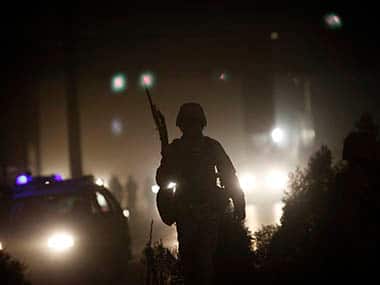 Afghan policeman keeps watch at the site of an attack in Kabul. Reuters