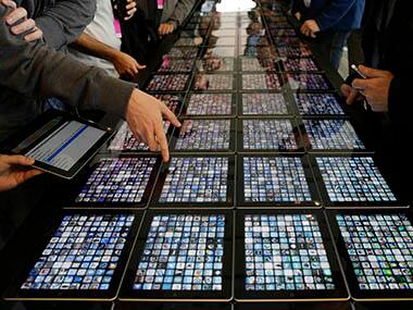 Developers look over new apps being displayed on iPads at the Apple Worldwide Developers Conference in San Francisco. AP