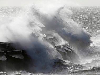 Waves batter into the sea wall of a marina in Brighton, south England, Monday, Oct. 28, 2013. A major storm with hurricane force winds is lashing much of Britain, causing flooding and travel delays including the cancellation of roughly 130 flights at London's Heathrow Airport. Weather forecasters say it is one of the worst storms to hit Britain in years. AP