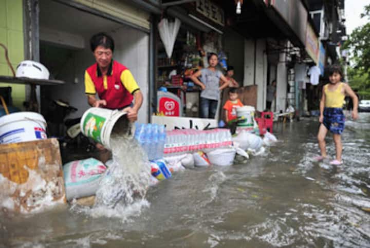 China sacks official who made flood victim carry him piggyback China sacks official who made flood victim carry him piggyback