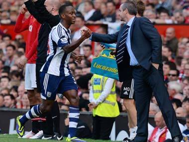 Saido Beradino celebrates with West Brom manager Steve Clarke after scoring against Manchester United. AFP