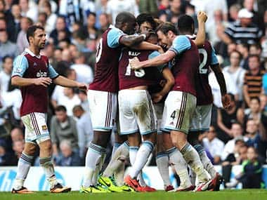 West Ham United players celebrate after their English midfielder Ravel Morrison scored their third goal during the English Premier League football match between Tottenham Hotspur and West Ham United. AFP 