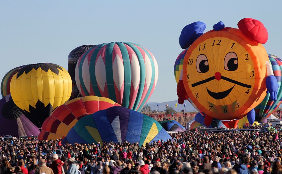 Hot air balloons, one of them shaped like a clock, are prepared before taking flight during the 42nd annual Albuquerque International Balloon Fiesta in Albuquerque, New Mexico. Thousands of spectators gathered on Saturday at the city's balloon park to watch more than 500 balloons of all shapes and sizes lift off in two stages during the so-called mass ascensions: Reuters Hot air balloons, one of them shaped like a clock, are prepared before taking flight during the 42nd annual Albuquerque International Balloon Fiesta in Albuquerque, New Mexico. Thousands of spectators gathered on Saturday at the city's balloon park to watch more than 500 balloons of all shapes and sizes lift off in two stages during the so-called mass ascensions: Reuters