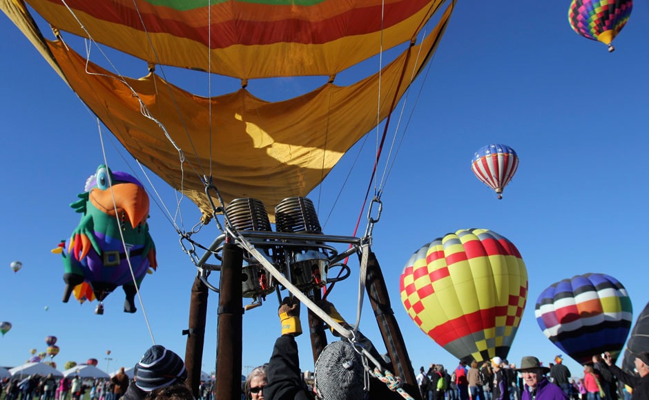 A pilot sits in the basket of a hot air balloon before it takes flight: Reuters A pilot sits in the basket of a hot air balloon before it takes flight: Reuters