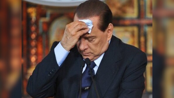 Berlusconi defeated, decides to back Italy govt