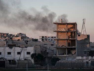 Smoke rises after a mortar shell hits a residential area in Syria. AP image