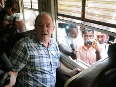 Channel 4’s British journalist Callum Macrae speaks to journalists inside a train as Sri Lankans blocked the train in protest against a documentary made by him, in Anuradhapura, Sri Lanka. AP. 