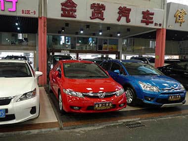 In this Friday, Nov. 22, 2013 photo, second hand cars are displayed at the Guangjun Used Auto Market in the southern Chinese city of Guangzhou. Explosive growth that transformed China into the world's biggest market for new cars is giving life to a new industry, secondhand autos. The challenge now is to develop a modern secondhand market in China, where most deals are done at big trading halls like the Guangjun market. AP